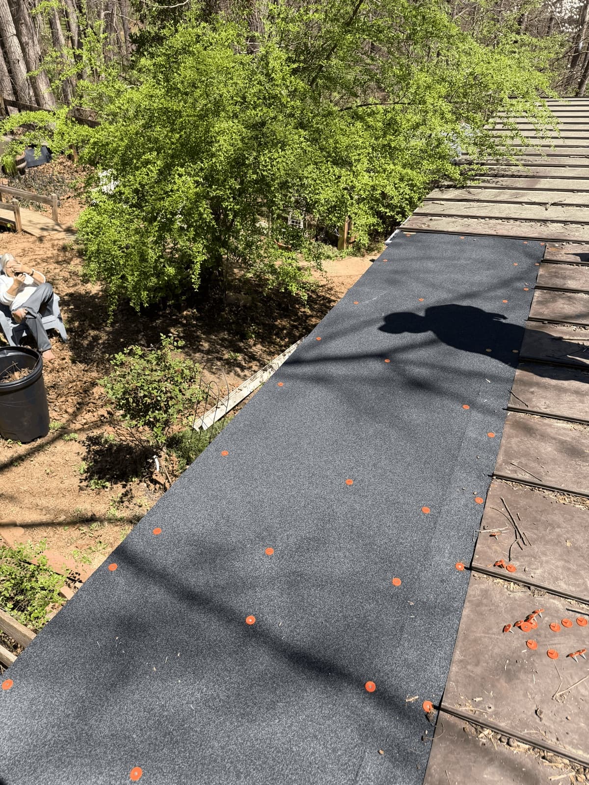 Roofing felt installation in progress